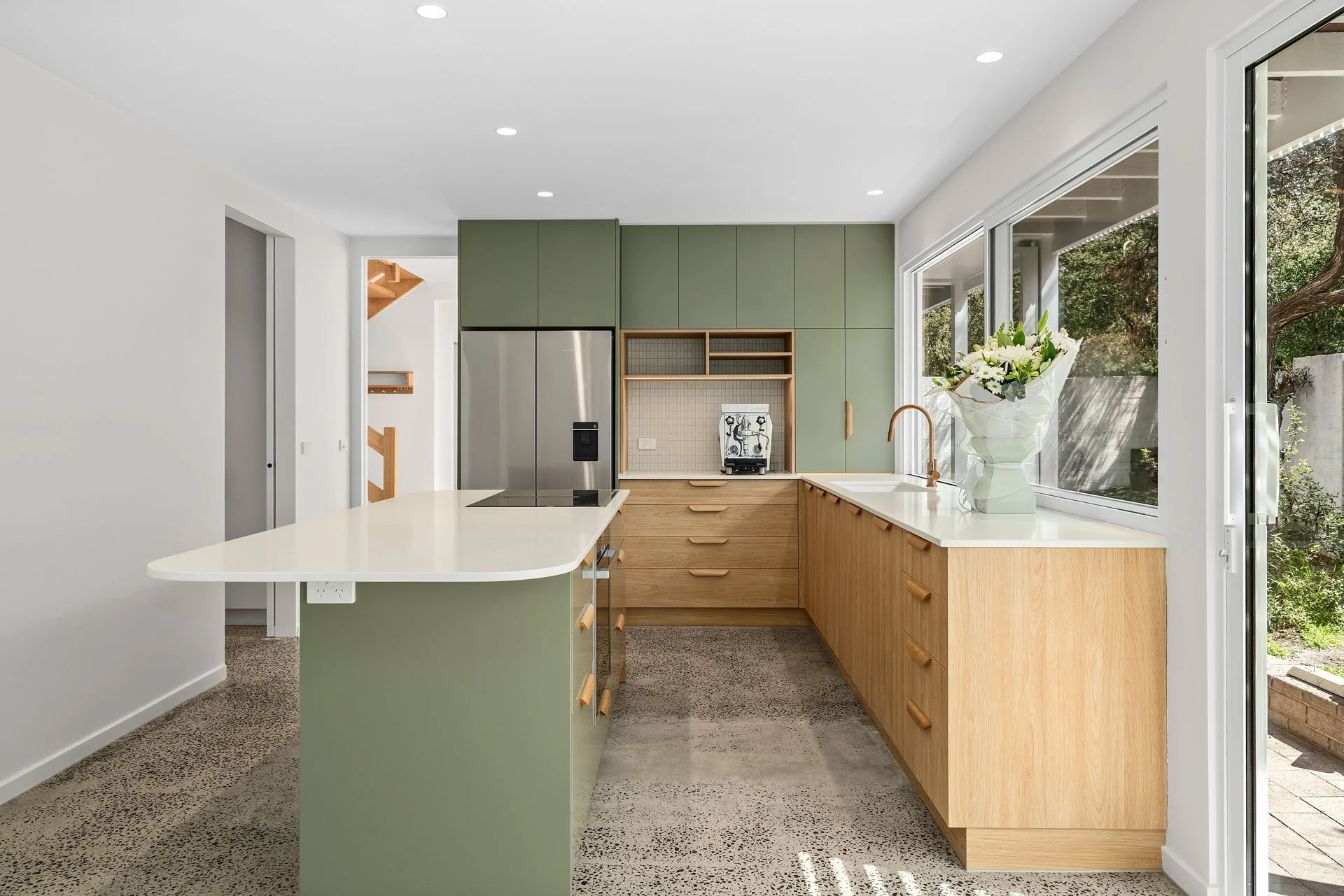 Sage-green kitchen with timber drawers, terrazzo floor and garden windows, Hotham Street Beaumaris — Eco Building Design