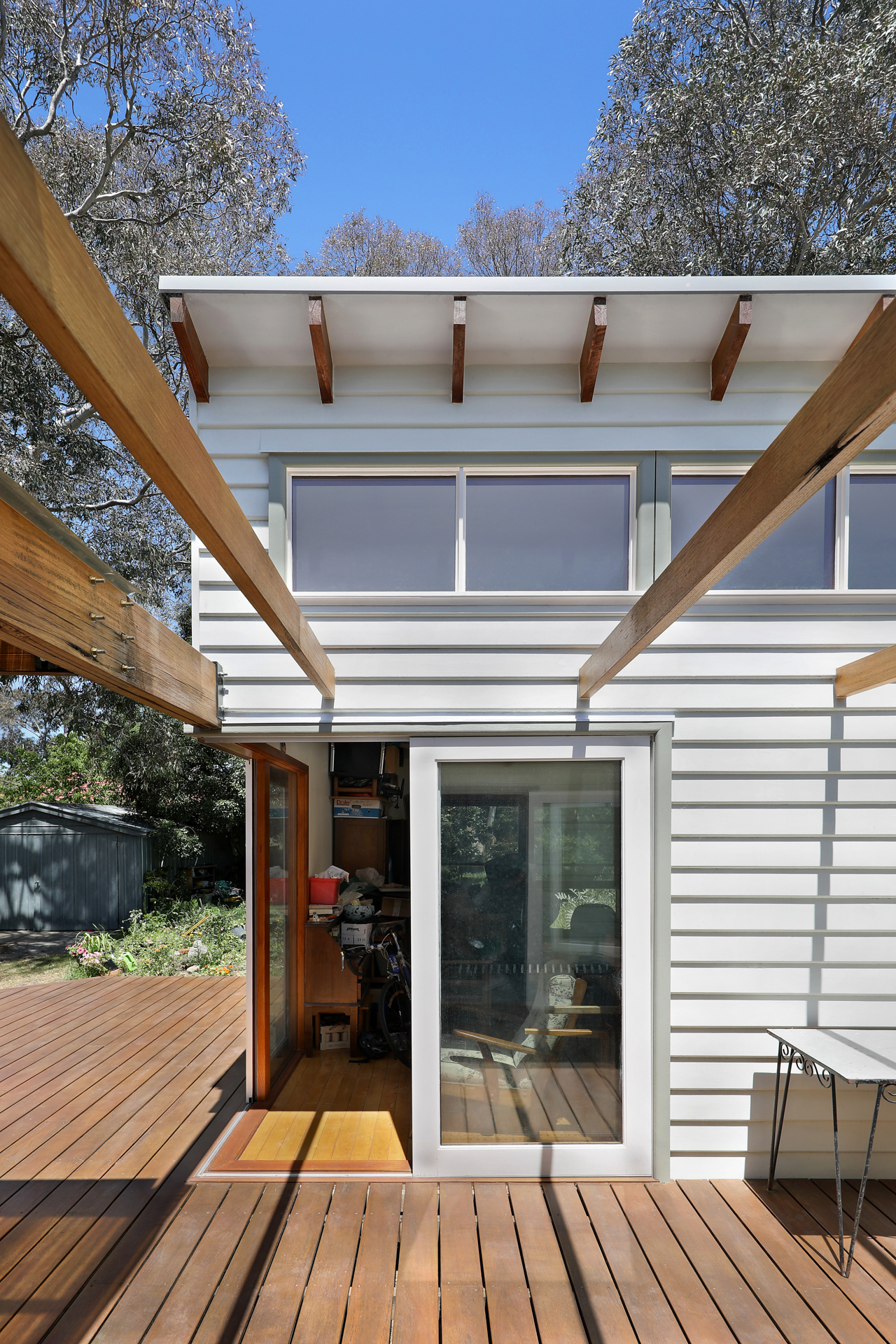Timber deck with large sliding doors connecting to pergola and garden, Joynt Street Macleod — Eco Building Design