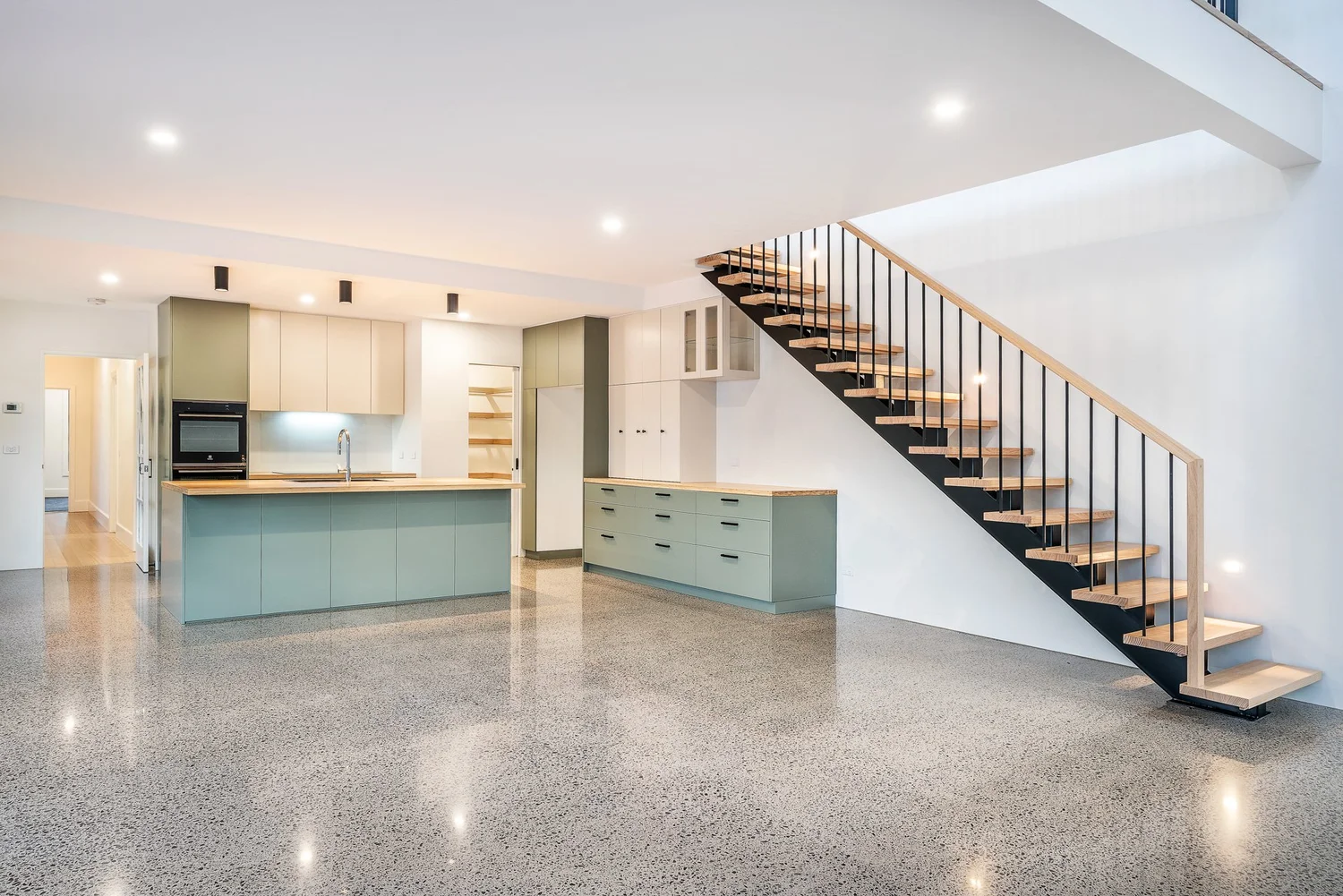 Open living, kitchen and staircase in a Bentleigh East family home